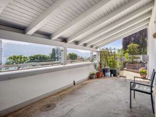 Enjoy breathtaking lake and mountain views from this covered patio, perfect for al fresco dining or relaxing.
