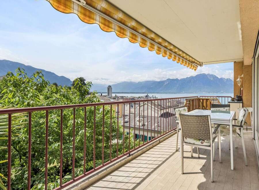 Enjoy breathtaking panoramic views of the lake and mountains from this stunning balcony.