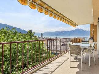 Enjoy breathtaking panoramic views of the lake and mountains from this stunning balcony.