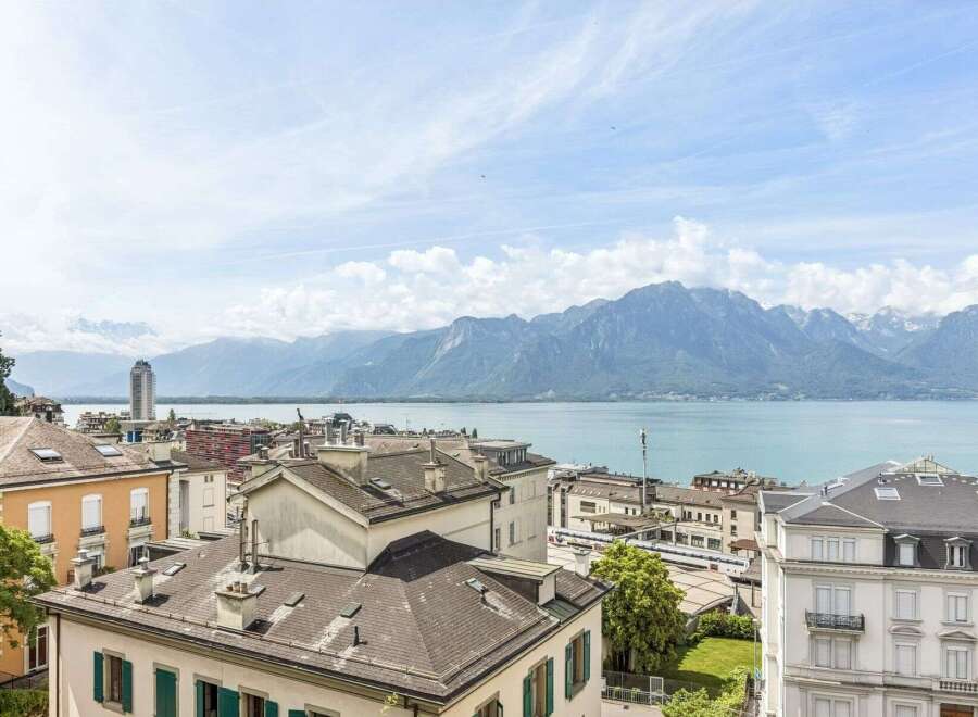 Experience breathtaking panoramic views of the serene lake and majestic mountains from this exceptional property.