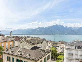 Experience breathtaking panoramic views of the serene lake and majestic mountains from this exceptional property.
