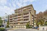 Discover this stunning apartment building featuring multiple balconies with awnings, offering ample outdoor space and protection from the sun.