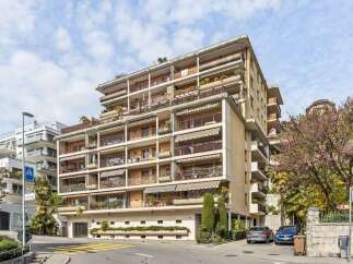 Discover this stunning apartment building featuring multiple balconies with awnings, offering ample outdoor space and protection from the sun.