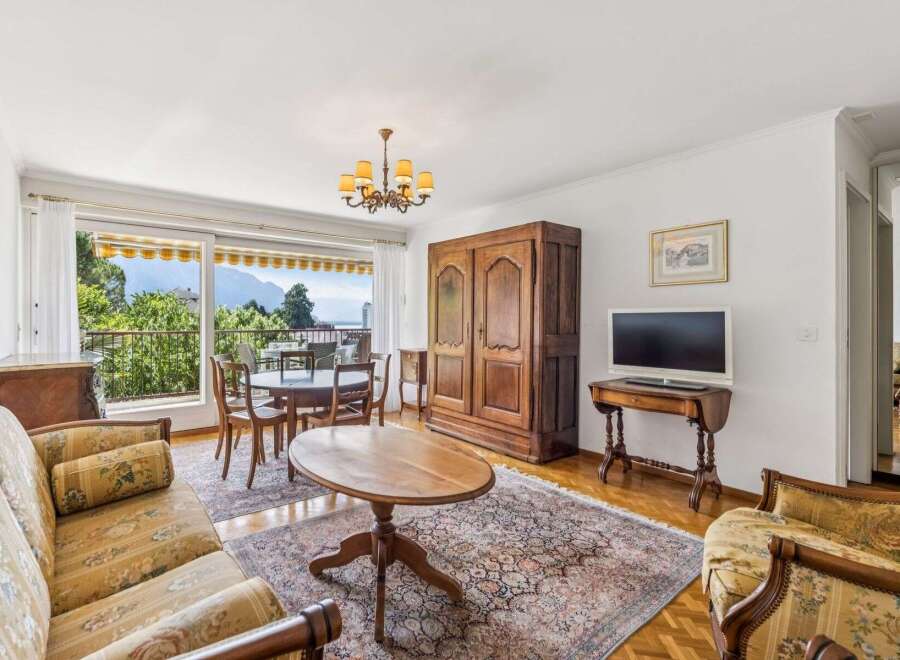 Experience breathtaking mountain and lake views from this charming living and dining area.
