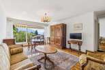 Experience breathtaking mountain and lake views from this charming living and dining area.