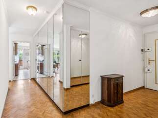 Step into this charming hallway featuring a stunning floor-to-ceiling mirrored wardrobe that amplifies the sense of space and light.