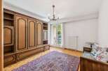 This charming room features a large, built-in wooden wardrobe offering ample storage space.