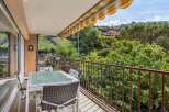 Enjoy your morning coffee on this charming balcony overlooking lush greenery and rolling hills.