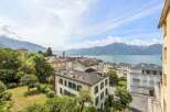 Experience breathtaking panoramic views of the serene lake and majestic mountains from this exquisite property.