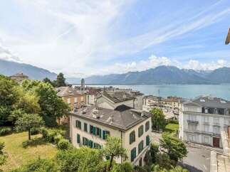 Experience breathtaking panoramic views of the serene lake and majestic mountains from this exquisite property.