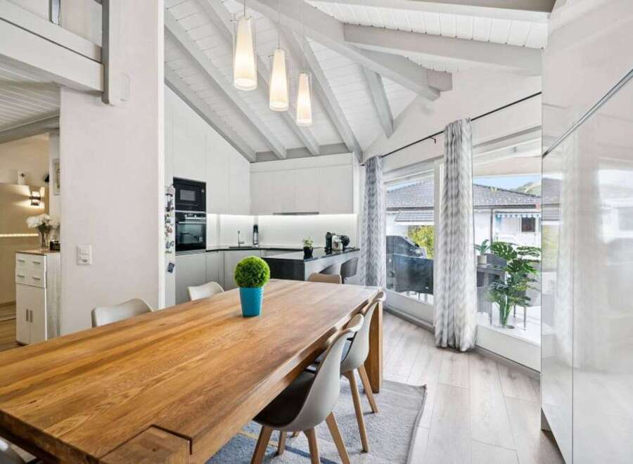 Experience modern living in this stunning open-concept space, featuring a sleek kitchen with integrated appliances and a spacious dining area perfect for entertaining.