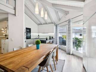 Experience modern living in this stunning open-concept space, featuring a sleek kitchen with integrated appliances and a spacious dining area perfect for entertaining.