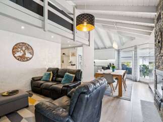 Experience modern living in this spacious open-concept home featuring a vaulted ceiling and a striking stone fireplace.