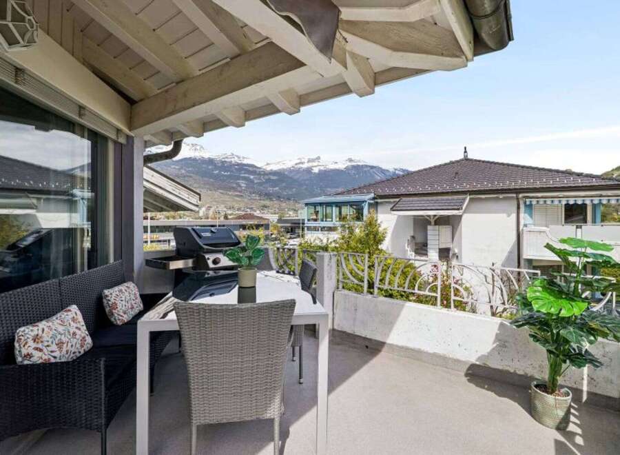 Enjoy breathtaking mountain views from this charming balcony, perfect for outdoor dining and relaxation.