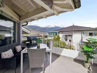 Enjoy breathtaking mountain views from this charming balcony, perfect for outdoor dining and relaxation.