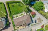 Discover this stunning aerial view of a modern home featuring a spacious, well-maintained lawn and a neatly trimmed hedge.