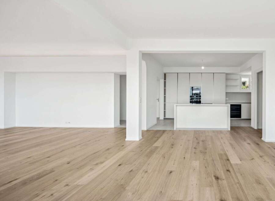 Experience modern living in this spacious, open-concept home featuring a sleek, contemporary kitchen with integrated appliances and a central island.