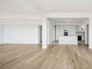 Experience modern living in this spacious, open-concept home featuring a sleek, contemporary kitchen with integrated appliances and a central island.