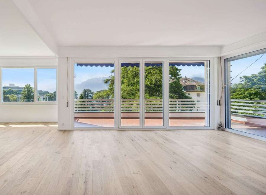 Experience breathtaking views from this spacious living area, featuring expansive windows that flood the room with natural light.