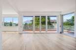 Experience breathtaking views from this spacious living area, featuring expansive windows that flood the room with natural light.