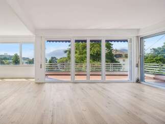 Experience breathtaking views from this spacious living area, featuring expansive windows that flood the room with natural light.