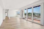 Experience modern living in this spacious, light-filled apartment featuring expansive floor-to-ceiling windows that offer stunning views.