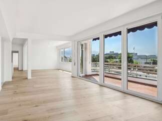 Experience modern living in this spacious, light-filled apartment featuring expansive floor-to-ceiling windows that offer stunning views.