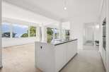Experience breathtaking panoramic views of mountains and a serene lake from this stunning modern kitchen.