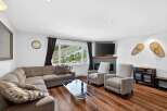 Experience breathtaking mountain views from this cozy living room, featuring a large sectional sofa and a modern fireplace.