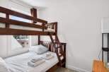 This charming bedroom features a space-saving bunk bed, perfect for families or accommodating guests.