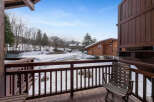 Experience the charm of a winter wonderland from this inviting balcony, offering picturesque views of snow-covered landscapes and traditional wooden chalets.