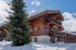 Experience the charm of a winter wonderland in this stunning wooden chalet, nestled amidst snow-covered landscapes.