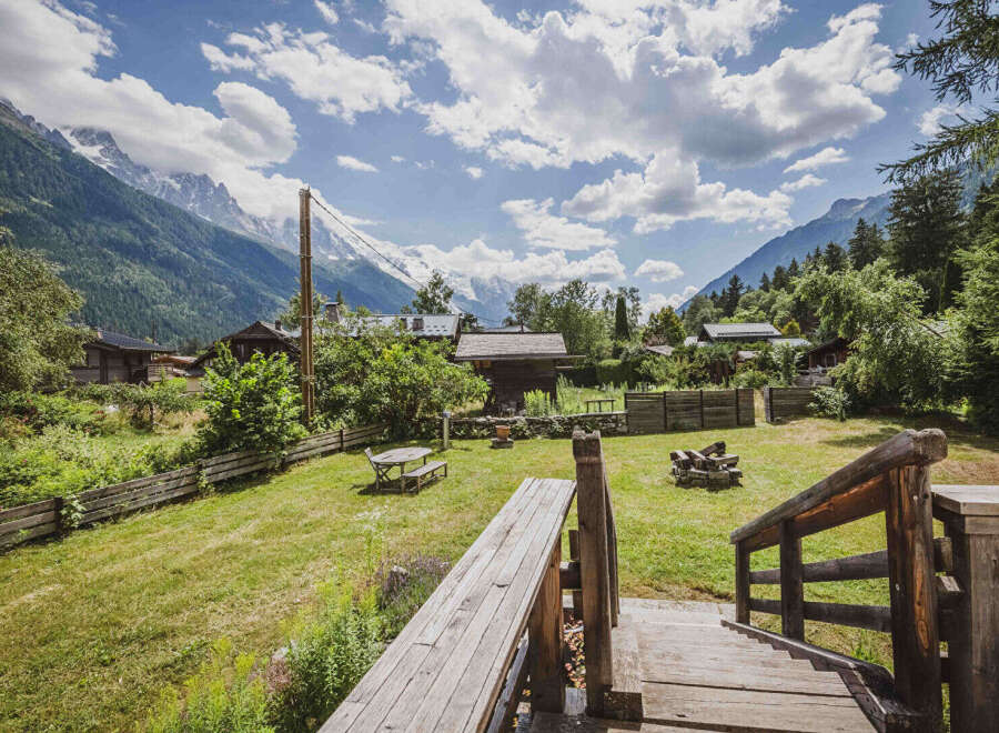 Experience the charm of mountain living with this picturesque property, featuring a cozy wooden cabin nestled amidst lush greenery and stunning alpine views.
