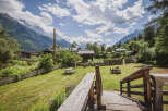 Experience the charm of mountain living with this picturesque property, featuring a cozy wooden cabin nestled amidst lush greenery and stunning alpine views.