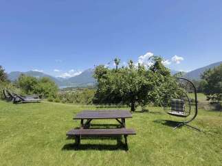 Enjoy breathtaking mountain and lake views from this stunning property's outdoor seating area.