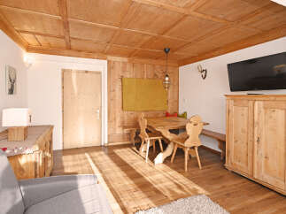 Experience rustic charm in this inviting dining area, featuring a solid wood table and benches perfect for family meals.