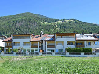 Discover modern living in this multi-unit property featuring sleek white facades and warm wooden accents.