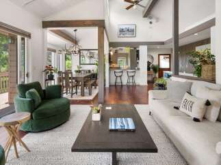 Experience the best of open-concept living in this stunning home, featuring a spacious living area seamlessly connected to a modern kitchen and dining space.