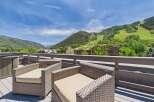 Enjoy breathtaking mountain views from this stunning deck, complete with comfortable seating and a relaxing hot tub.