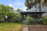 Charming single-family home with a welcoming entrance featuring a black door and multi-colored tile steps.