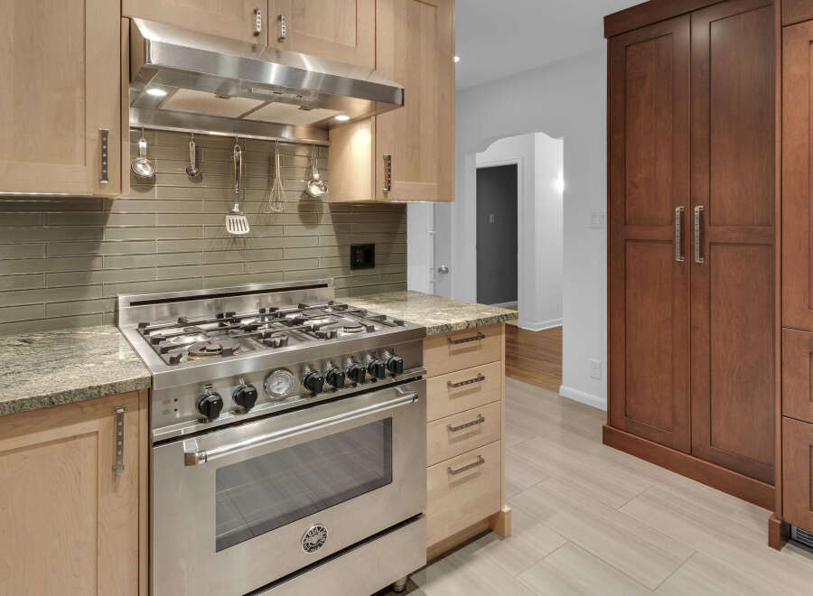 Experience culinary excellence in this stunning kitchen, featuring a professional-grade stainless steel range and a sleek subway tile backsplash.