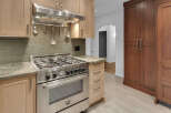 Experience culinary excellence in this stunning kitchen, featuring a professional-grade stainless steel range and a sleek subway tile backsplash.