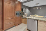 Discover this stunning kitchen featuring sleek, custom wood cabinetry and a built-in stainless steel microwave.