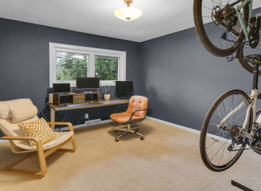 This home office features a dual-monitor setup with a long desk, perfect for productivity.