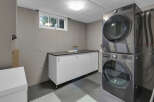 This laundry room features a stacked LG washer and dryer set, offering a space-saving solution.