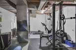Transform your basement into a personal fitness sanctuary with this well-equipped home gym.