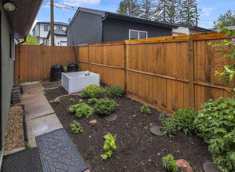 Discover this charming backyard oasis, perfect for gardening enthusiasts.