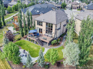 Experience luxurious outdoor living with this stunning backyard featuring a multi-level deck, perfect for entertaining guests.