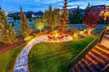 Experience outdoor living at its finest with this beautifully landscaped backyard, featuring a modern fire pit area perfect for gatherings.