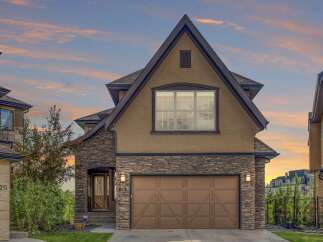 Experience luxury living in this stunning home featuring a striking stone facade and a warm, inviting stucco exterior.